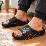 Black and orange SoleReset slides worn indoors