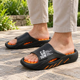 Black and orange SoleReset slides worn on a garden patio